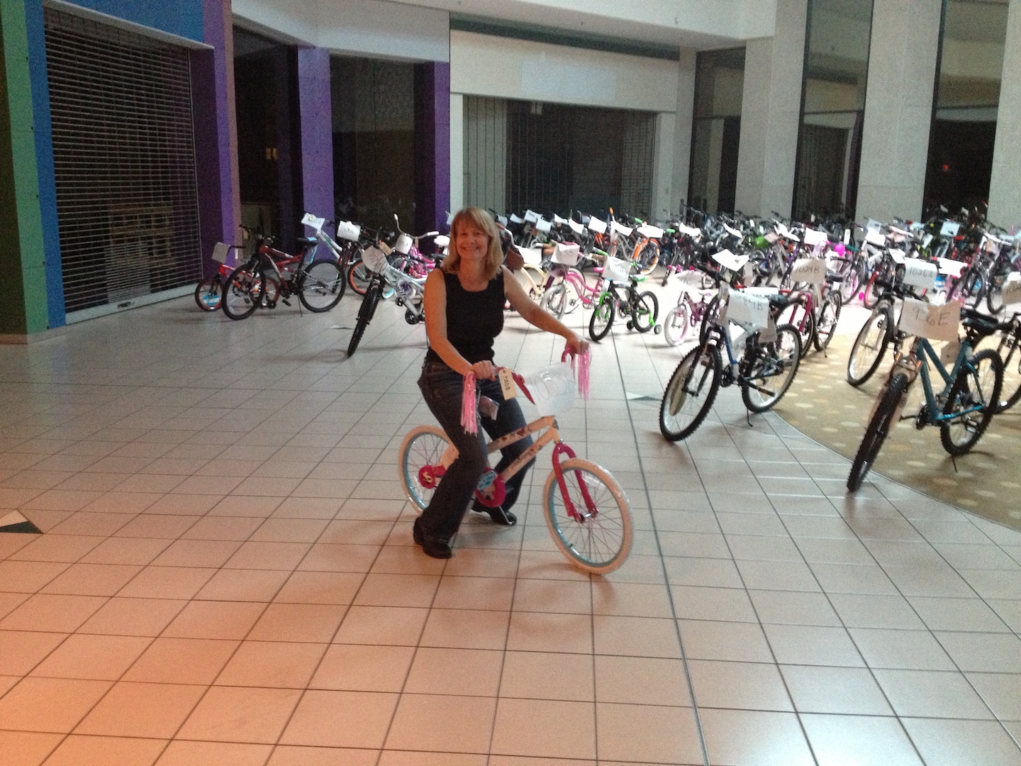 VIBE team members on a bicycle at Tampa Bay Salvation Army's Angel Tree Program