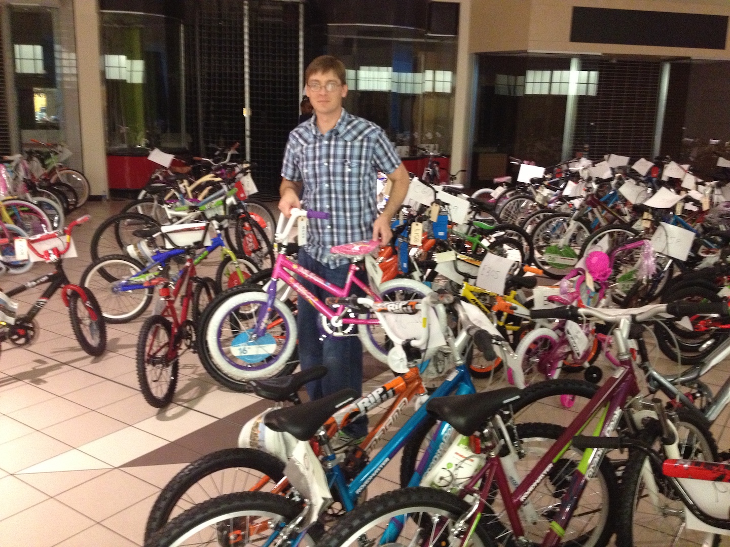 VIBE team member holding a bicycle at Tampa Bay Salvation Army's Angel Tree Program