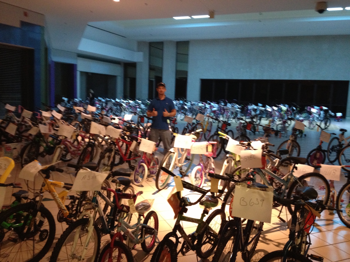 VIBE team member in the middle of a large group of bicycles Tampa Bay Salvation Army's Angel Tree Program