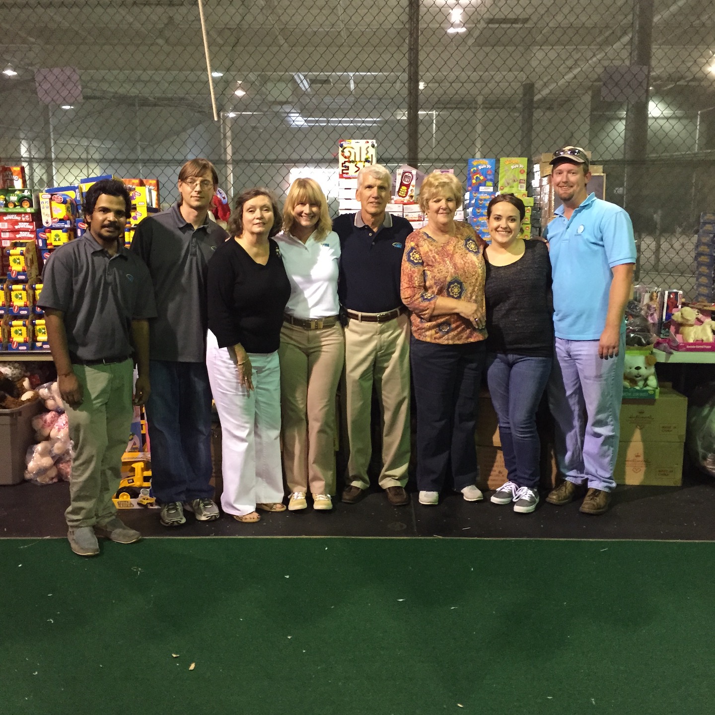 VIBE team members standing in front of toys at the 2014 Tampa Bay Salvation Army's Angel Tree Program