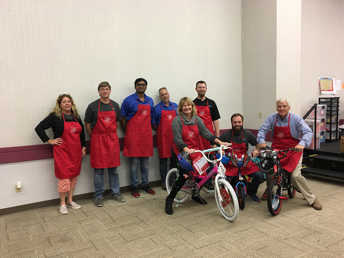 VIBE team during the 2018 Salvation Army Toy Sorting with team members standing and on bicycles