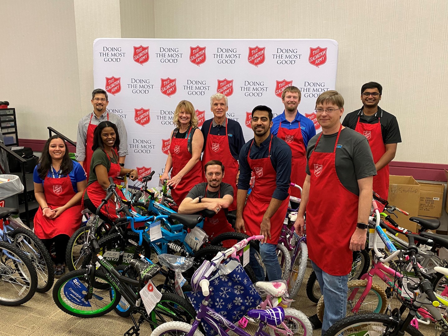 VIBE team during the 2019 Salvation Army Toy Sorting with team members standing with bicycles