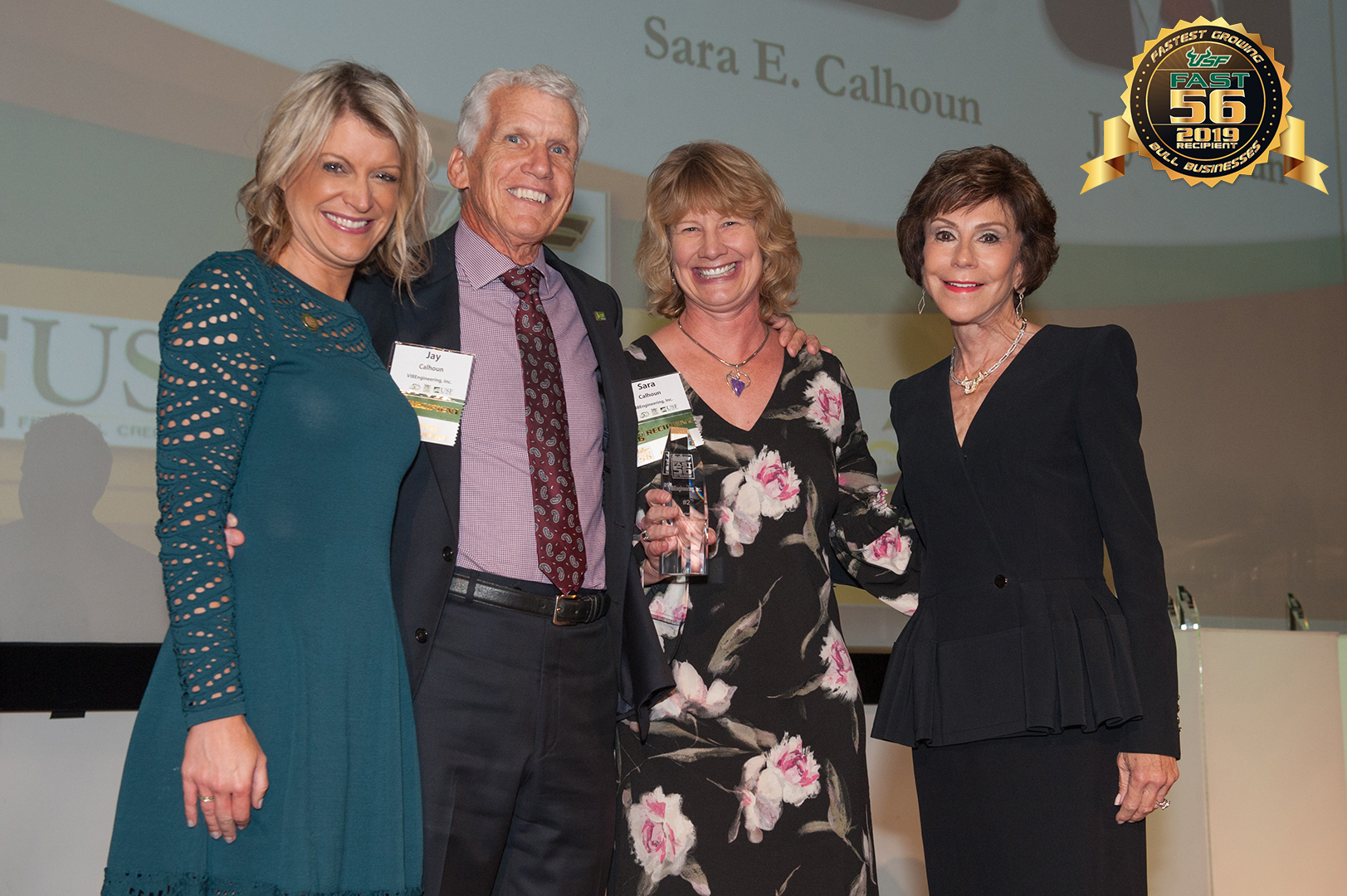 VIBE president and vice president with USF president receiving USF FAST 56 award